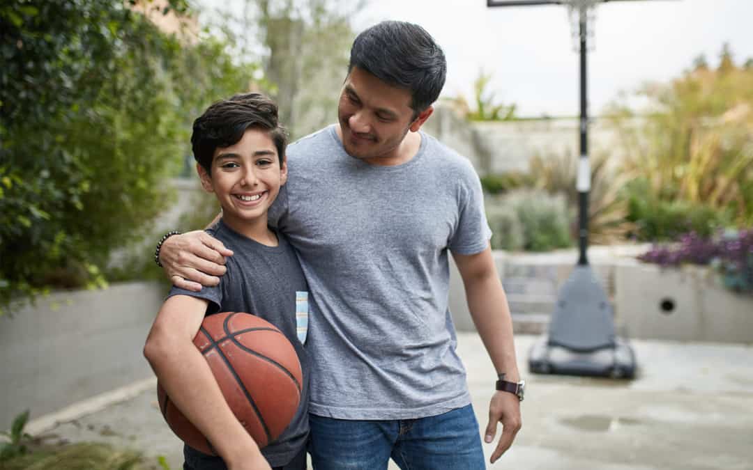 A parent and child together with a basketball